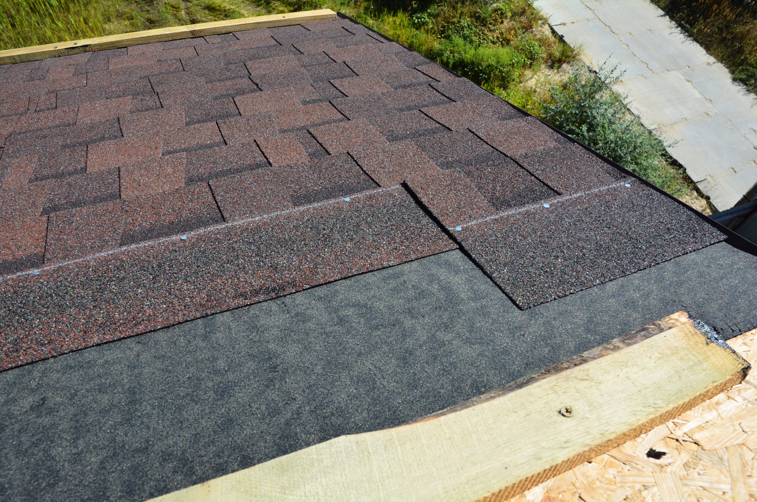 Laying and installing asphalt shingles. House Roof asphalt shingles repair. Roofing construction with roof tiles, asphalt shingles.